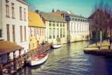 Canal with boats between old gabled houses, waiting in the queue